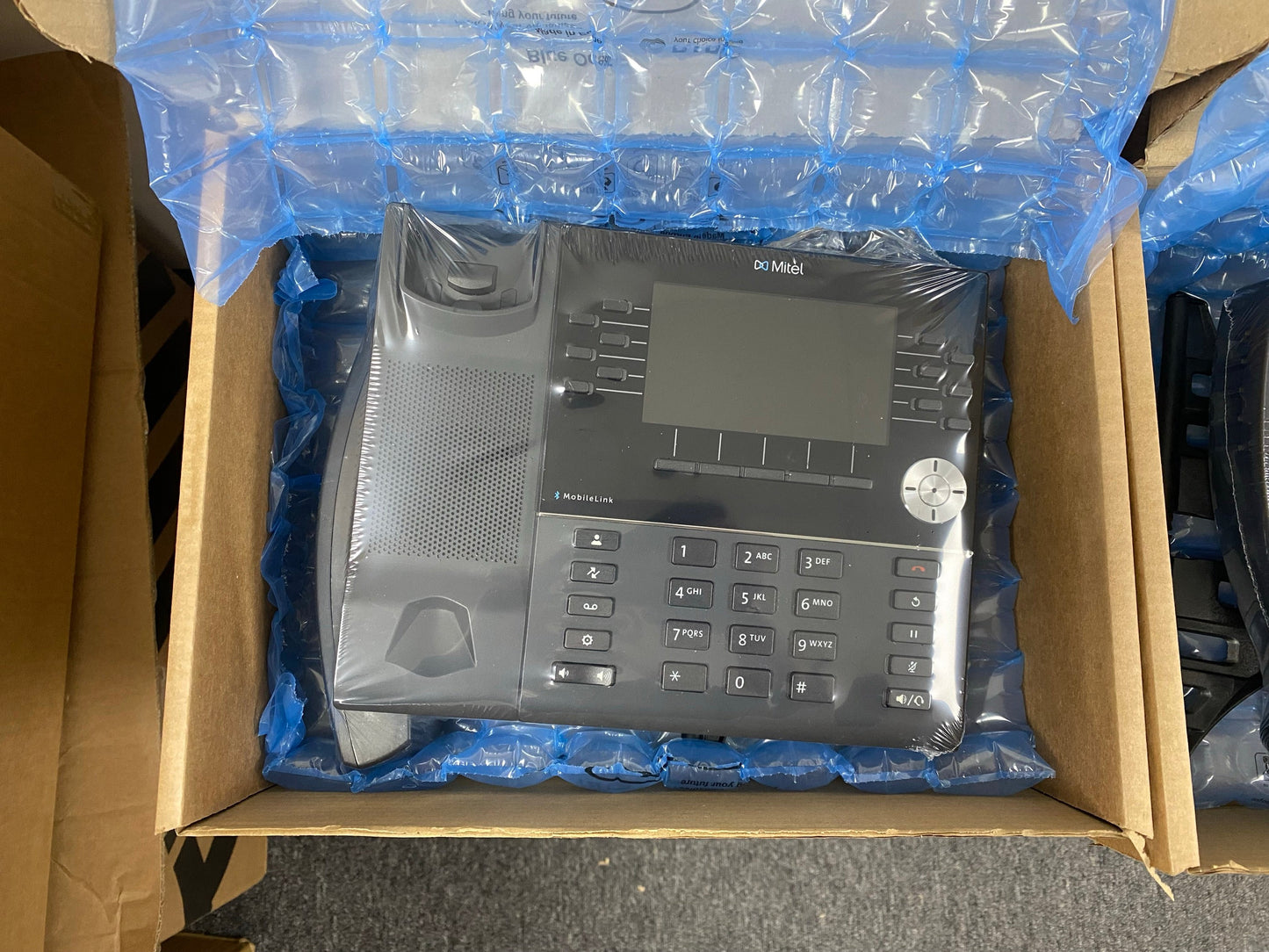 Mitel IP Phone in packaging with blue bubble wrap